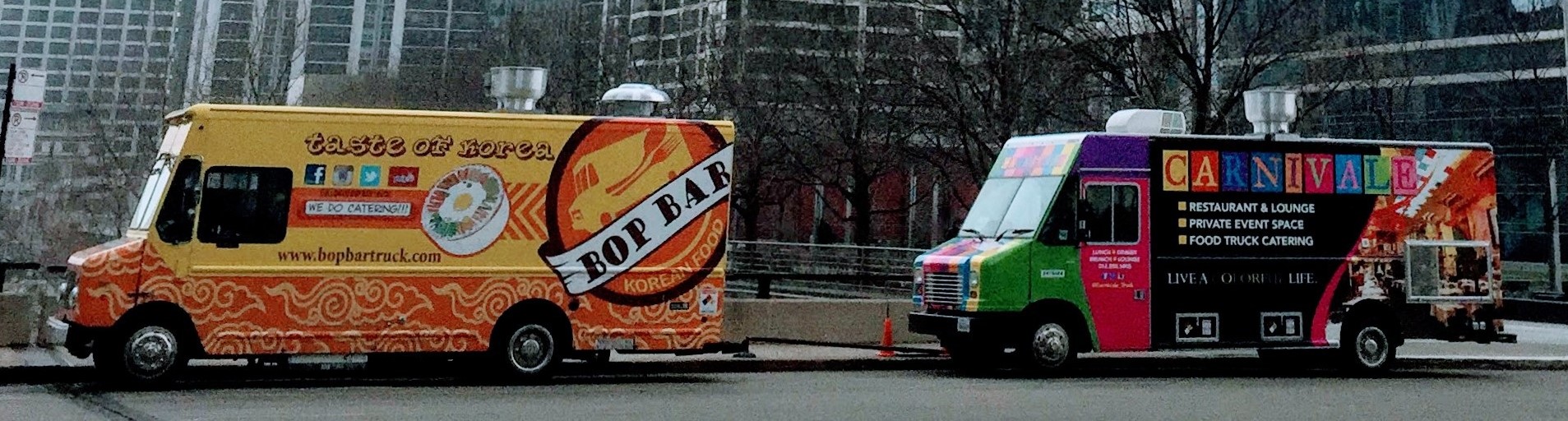 Colorful food trucks parked on a city street for restaurant and mobile food service